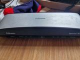 an image of a router sitting on a desk in front of a computer monitor