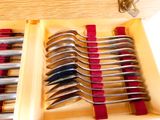 beaucoup de cuillères dans une boîte posée sur la table