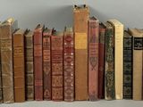 a lot of old books that are stacked on top of each other