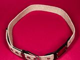 a close up of a white belt on a pink background