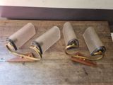 three rolls of toilet paper and a pair of scissors on a wooden table