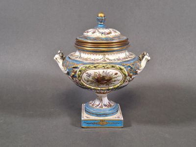 a blue and white vase with a lid on a stand