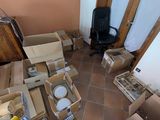 a room filled with boxes and a chair in it