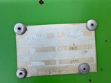 a close up of a metal plate on a green vehicle