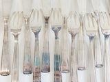 a lot of forks and spoons on the table