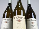 three bottles of wine sitting on top of a table next to each other