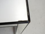 a close up of a mirror on a table