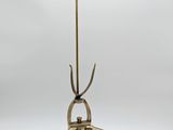 a brass plated table with a glass top and metal legs