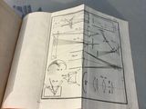 an open book with a drawing of a plane on it