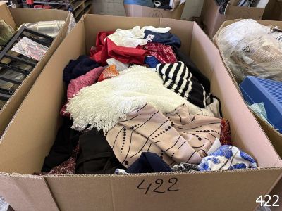 a cardboard box full of clothes in a room