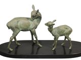 a statue of a deer and a baby deer on a black base