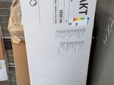a white refrigerator that is next to some boxes