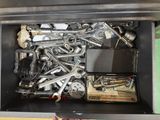 a black box filled with assorted tools on a table