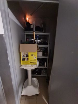 a box sitting on top of a toilet in a room