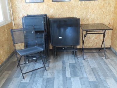 three chairs and a table in a room with a television