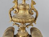 a large gold vase with a bird on top of it