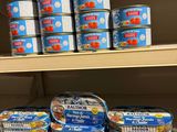 many cans of canned food on the shelves in the store