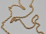 an 18k gold necklace with a twisted rope design