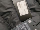 the label on the back of a black jacket is attached to the back of the jacket