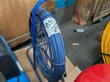 a blue air compressor and a red air compressor in a garage