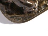 a bronze statue of a man riding a horse