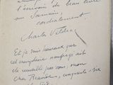 an old book with a handwritten poem on it sitting on a table