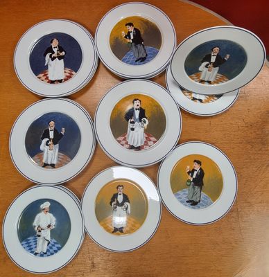 six plates with pictures of people on them on a table