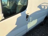 a white van that is parked on the side of the road