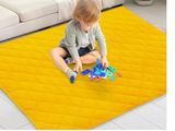 the child is playing with toys on the floor in the living room
