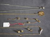 a lot of gold necklaces on a table