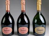 trois bouteilles de vin posées l'une à côté de l'autre sur une table