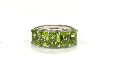 an image of a ring with three green stones