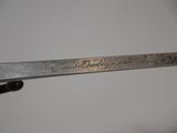 a close up of a knife with writing on it