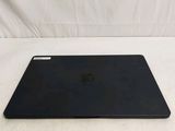 the back of a black laptop computer sitting on top of a white surface