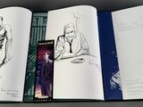 a book with a picture of a man in a suit and a woman in a dress and a man in a coat