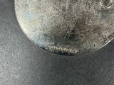 a close up of a piece of metal on a table
