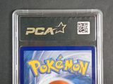 pokemon trading card in plastic case on a black surface