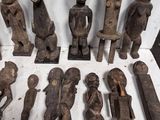 several pieces of carved wood sitting on top of a white surface