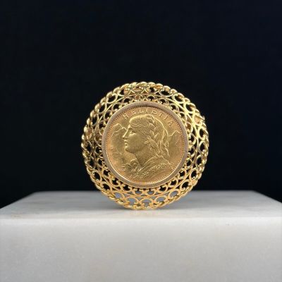 a gold ring with a portrait of a woman on it