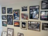a picture of a living room with a lot of pictures on the wall