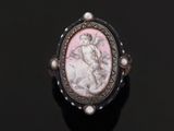 a close up of a ring with a picture of a woman on it