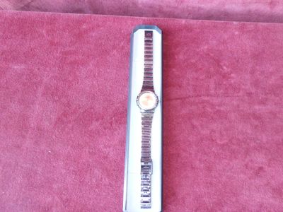 a watch that is laying on a red cloth