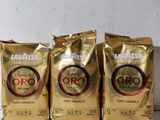 three bags of coffee sitting on top of a table next to each other