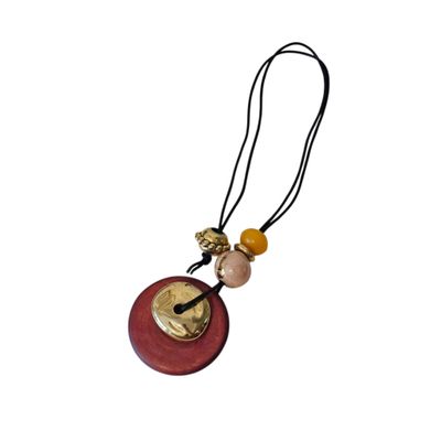 a close up of a necklace on a white background with a white background