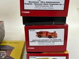 three boxes of firetrucks on a table next to each other