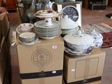 a pile of plates and bowls on a carton in a room
