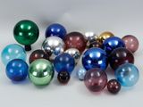 a lot of different colored glass balls on the table