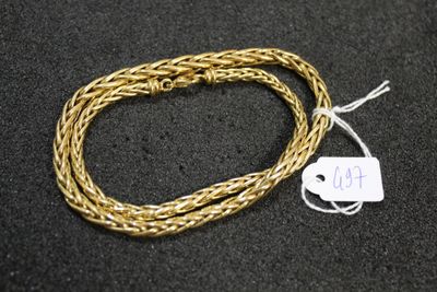 a close up of a gold chain with a tag on it