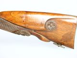 an old rifle with a wooden barrel and a metal handle