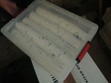 a plastic container with a sheet of music on top of it